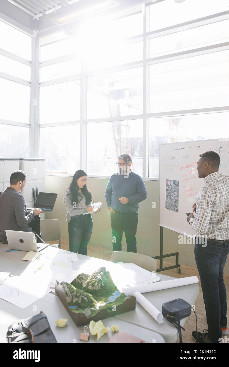 Land use planners talking in sunny community center Stock Photo Alamy