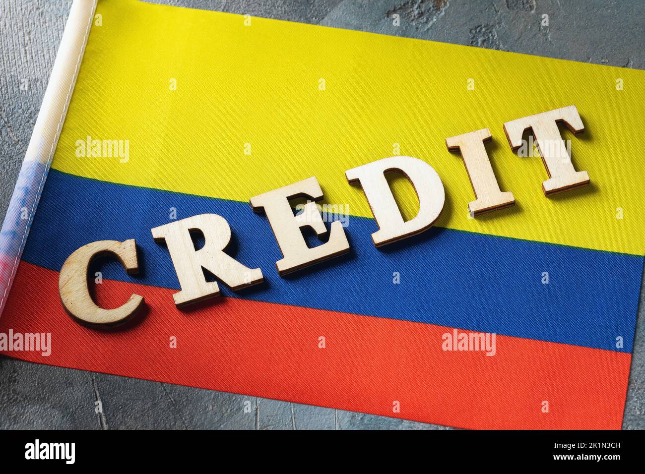 Wooden letters text and Colombian flag on abstract background, concept of using credit in Colombia Stock Photo