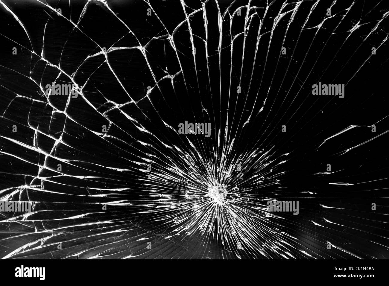 Cracked smart phone screen, abstract pattern with white lines on black background Stock Photo