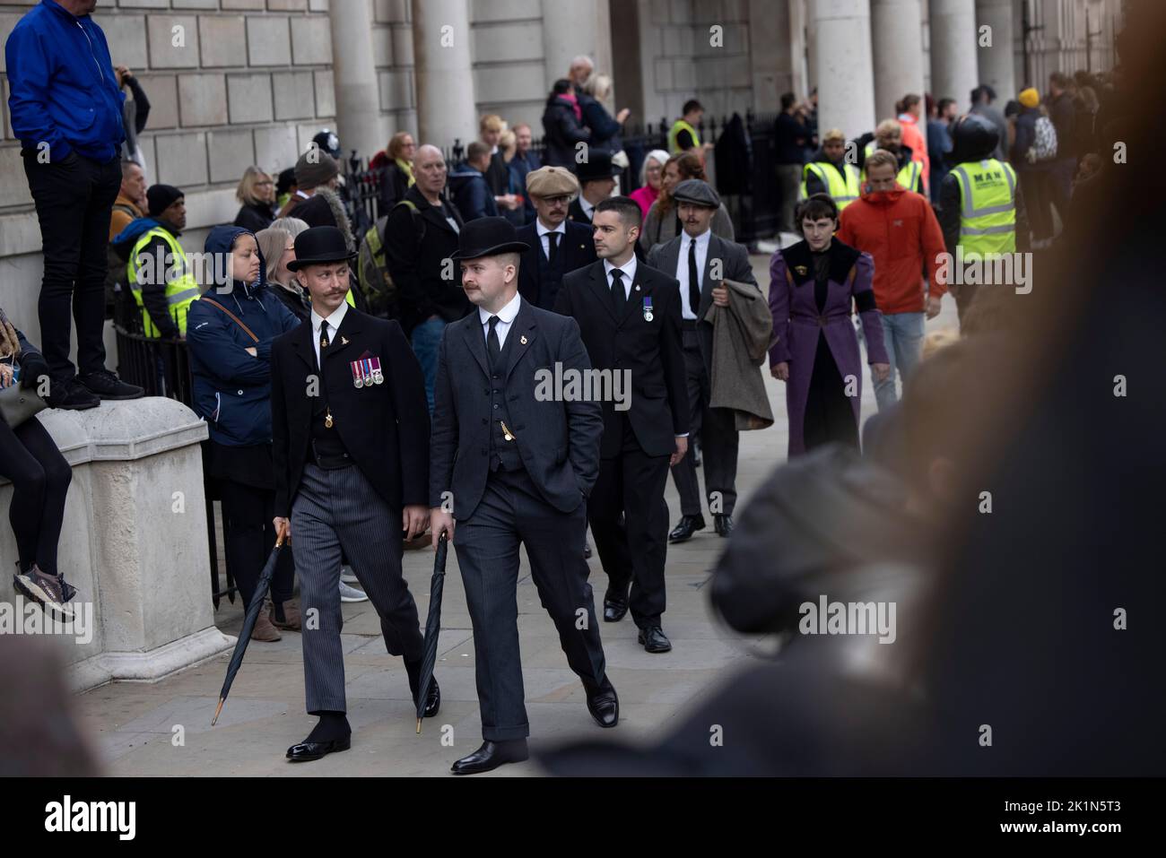 Mourners seen dressed formally for the final procession of Her Majesty