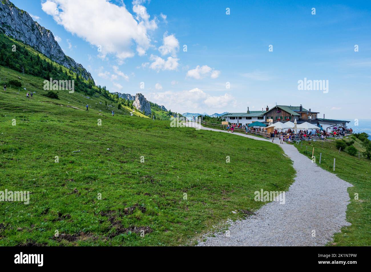 Aschau, Bavaria, Germany - July 14, 2020: tourists visiting the Steinlingalm in front of the Kampenwand, a mountain in Bavaria, Germany Stock Photo