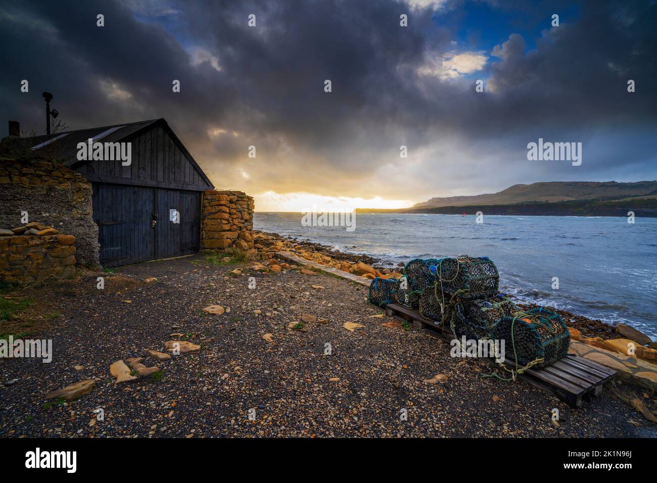 Boat shed and lobster traps at Kimmeridge Bay, Kimmeridge, Dorset, England, Uk Stock Photo