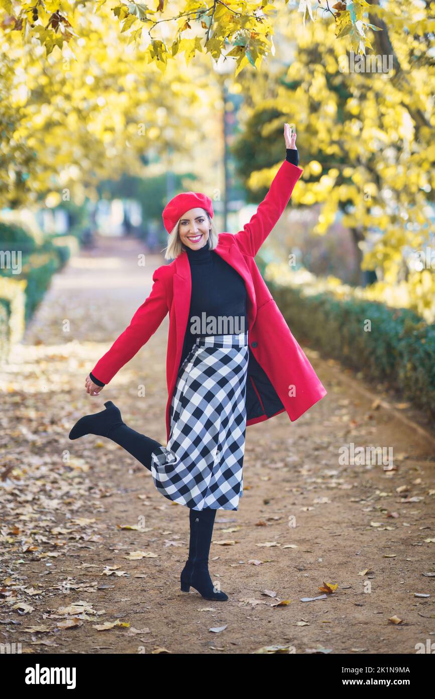 Cheerful woman in stylish outfit in park Stock Photo