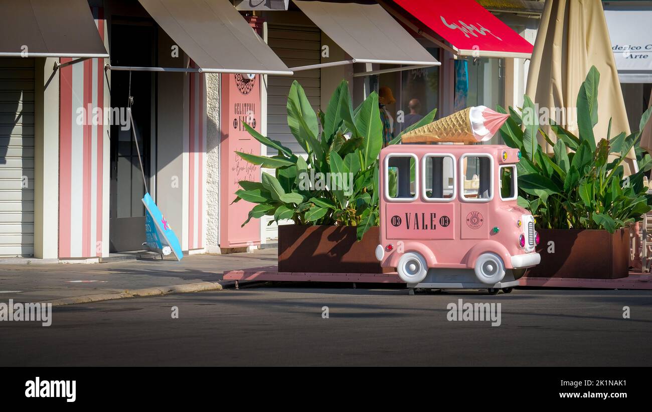 Viareggioi, Italy - June 8, 2022: Fun, miniature pink ice cream truck advertising a gelato shop in Viarregio, Italy. Stock Photo
