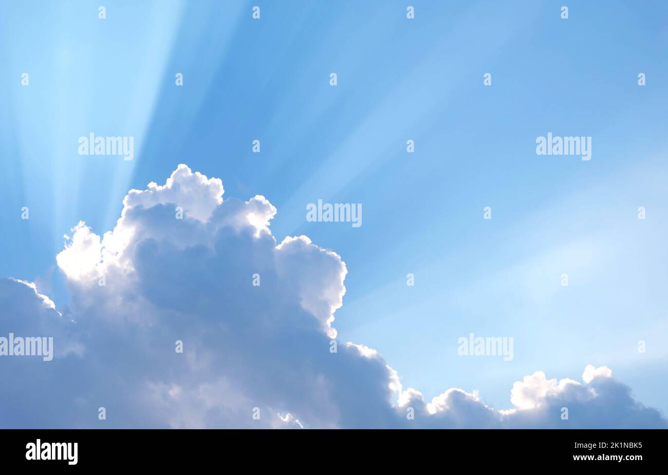 Fantastic Sunbeam Shining Through the Fluffy Clouds Stock Photo