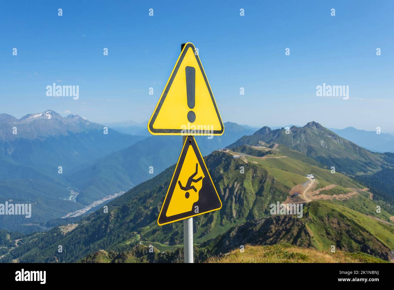 Sign man falling from a height, danger of falling from a cliff, mountain collapses, warning of an abyss Stock Photo