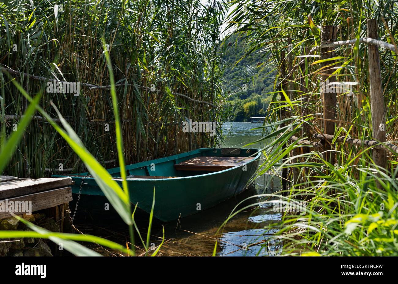 Small wooden boat between reed at the lake , leisuret time Stock Photo
