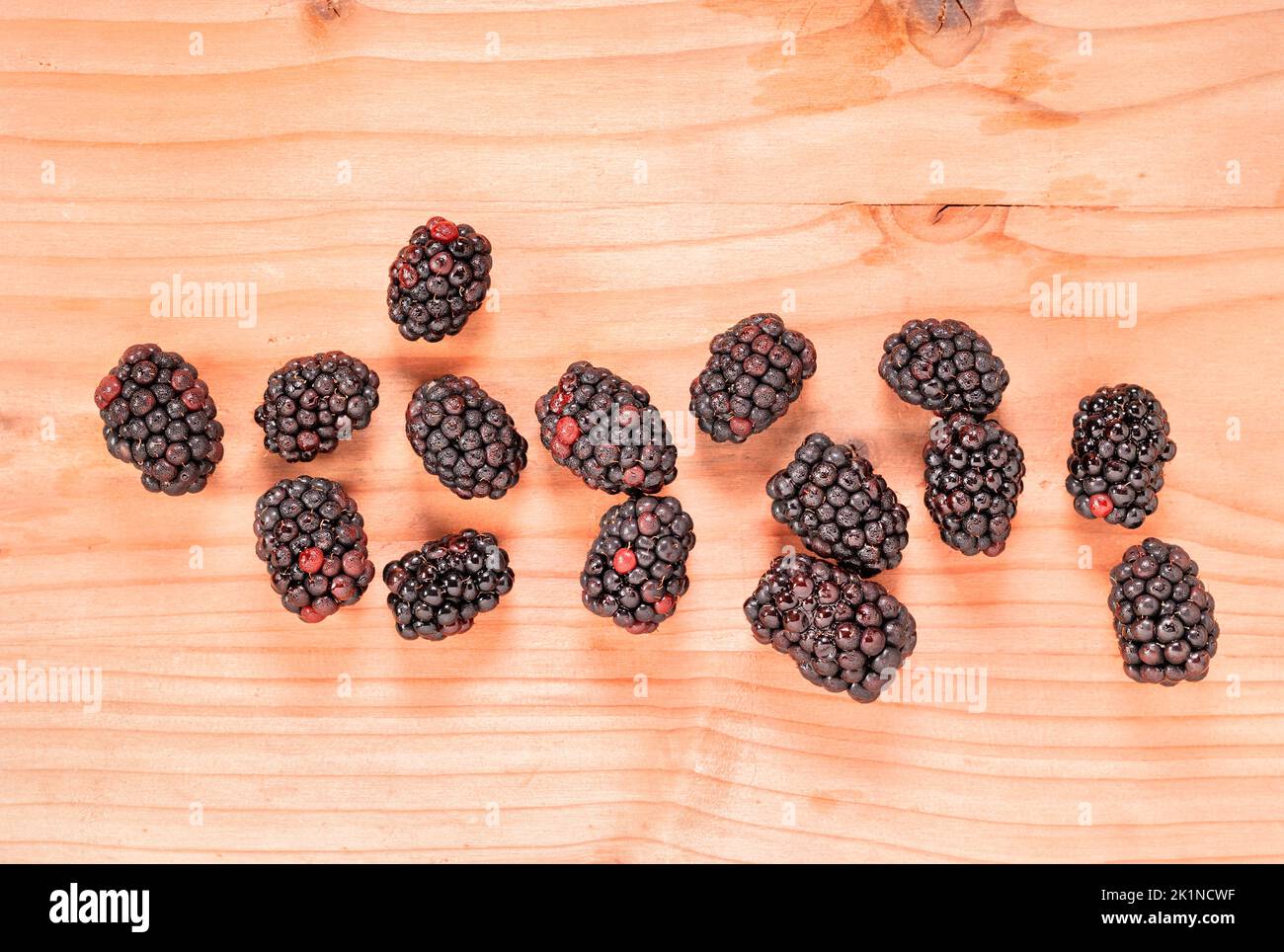 Fresh wild blackberries on wooden table , edible fruit Stock Photo