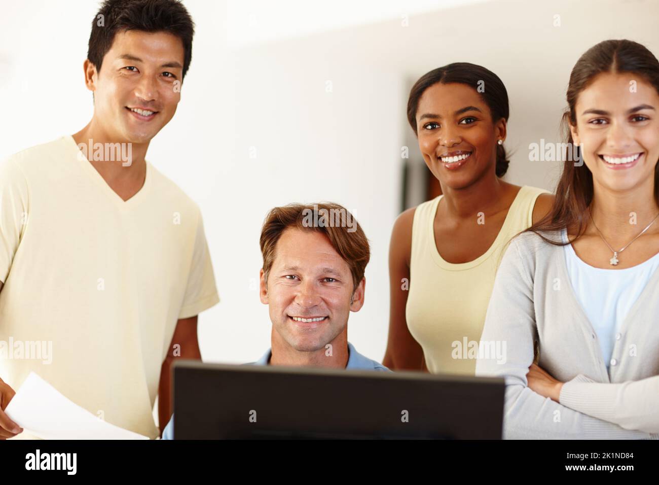 Teamwork yields great results. Portrait of a work team gathered around ...