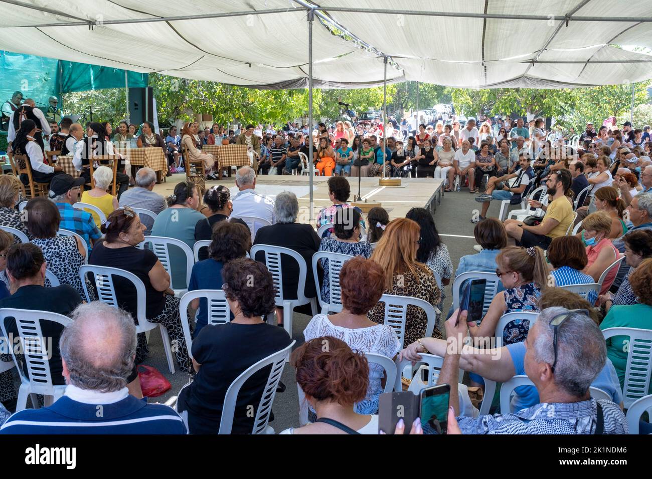 Crowds listen to traditional music at the Statos-Ayios Fotios Rural Festival, Paphos Region, Cyprus. Stock Photo