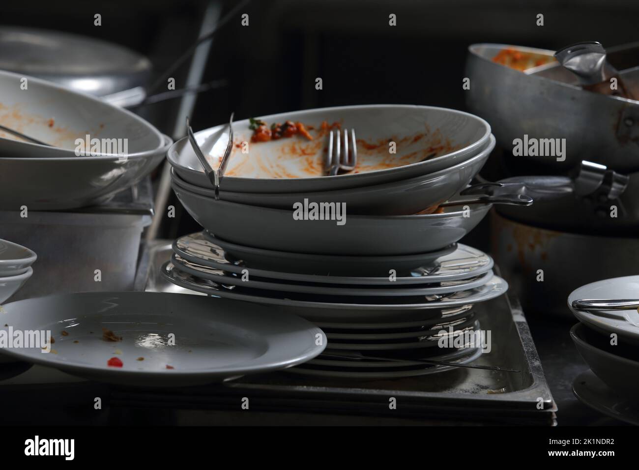 restaurant and catering - dirty dishes and dishes to wash in the kitchen Stock Photo