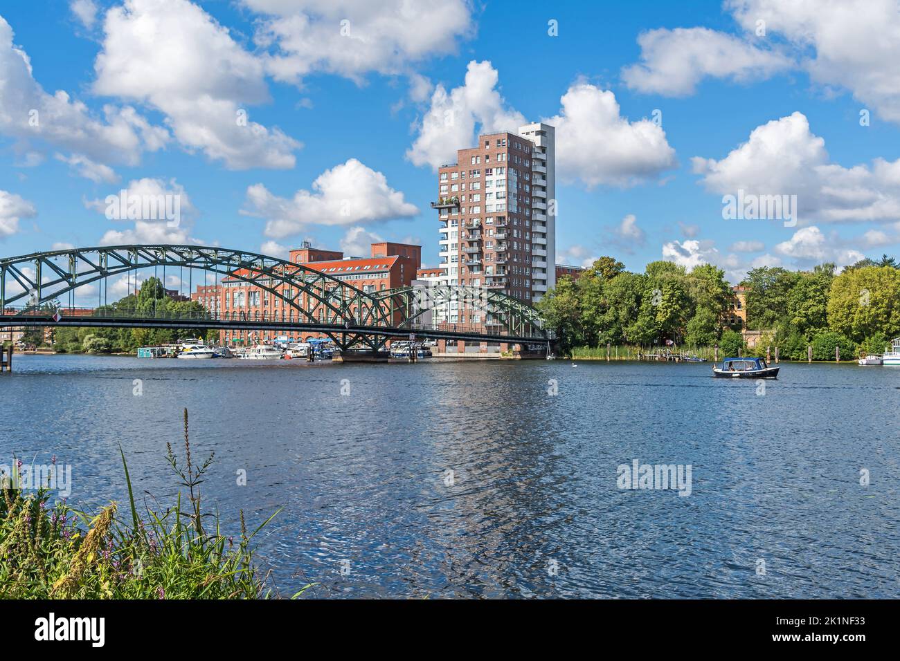 Berlin, Germany - August 6, 2022: River Havel with its arch bridge Eiswerderbruecke, marina and residential buildings at the street Frieda Arnheim Pro Stock Photo