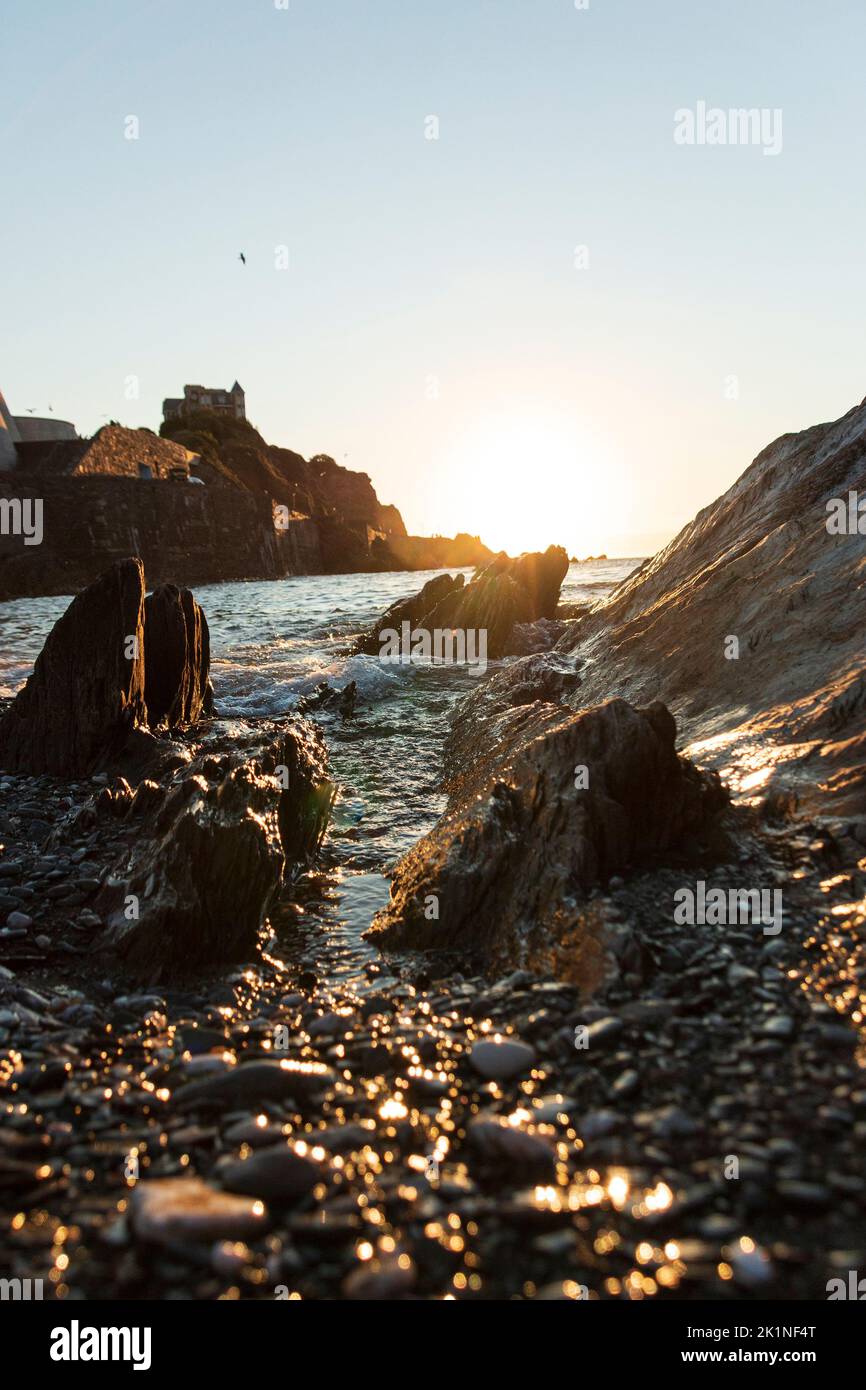 A close up view of the ocean water waves coming though the rocks Stock Photo