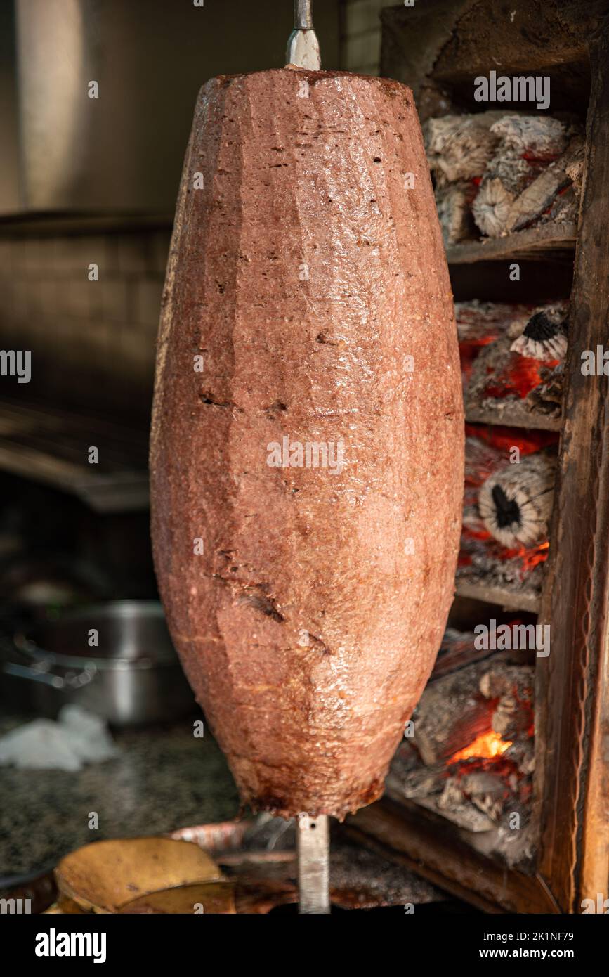 Chef cutting traditional Turkish food Shawarma meat Doner Kebab in the outdoor restaurant. , Turkish Kebab iskender doner Stock Photo