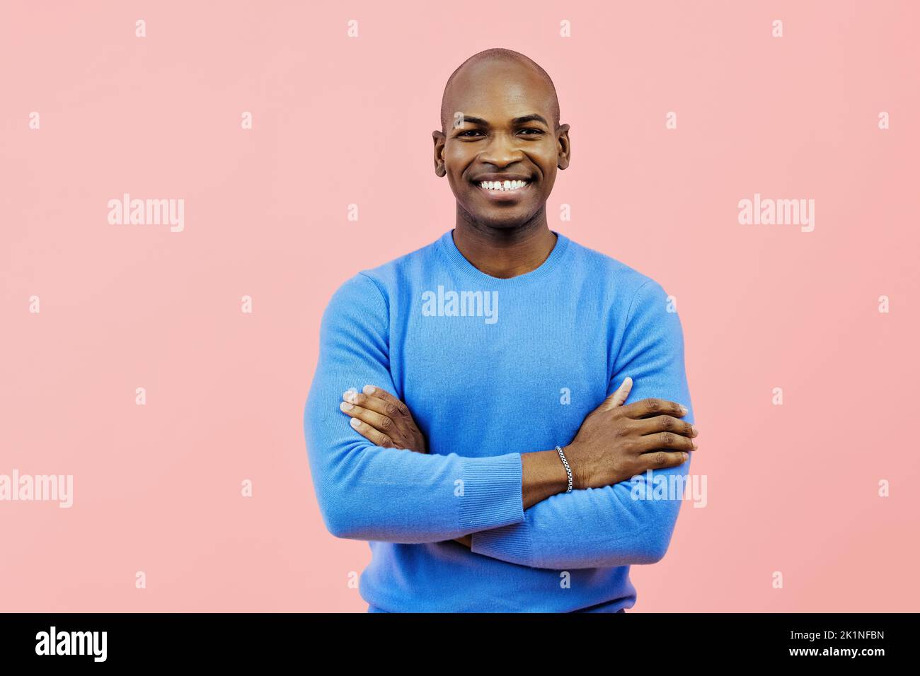 man smiling with folded arms indoors studio Stock Photo