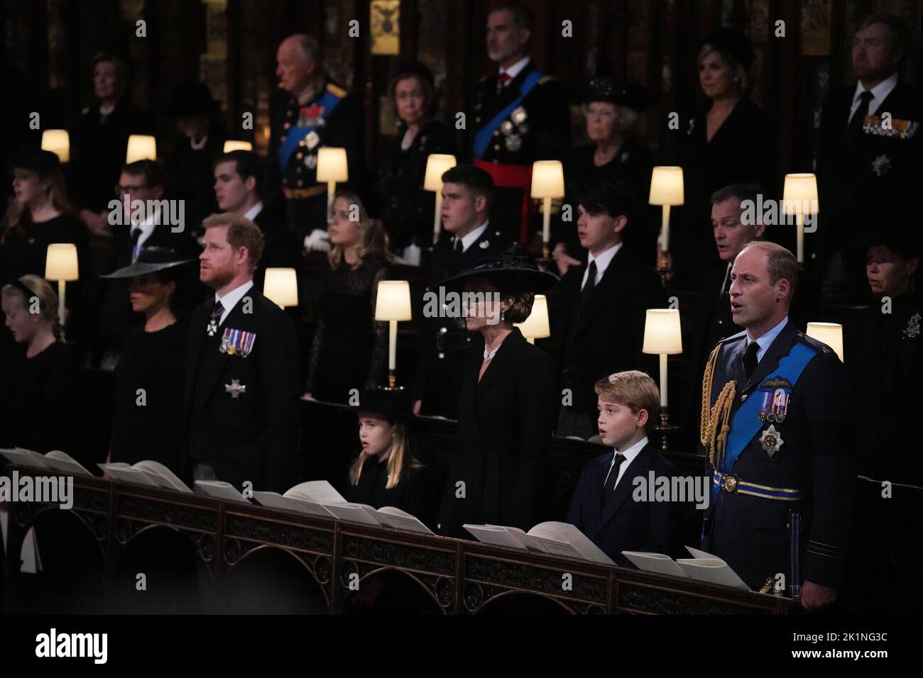 (front row, left to right) The Duchess of Sussex, the Duke of Sussex, Princess Charlotte, the Princess of Wales, Prince George, and the Prince of Wales during the Committal Service for Queen Elizabeth, at St George's Chapel in Windsor Castle, Berkshire. Picture date: Monday September 19, 2022. Stock Photo