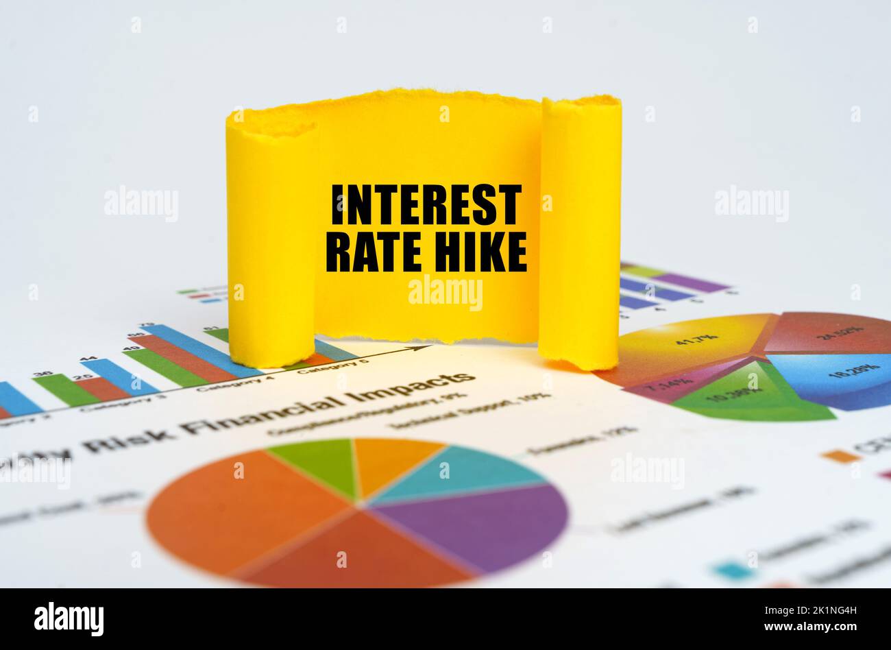 Business concept. Against the background of graphs and charts, a yellow paper plate with the inscription - Interest rate hike Stock Photo