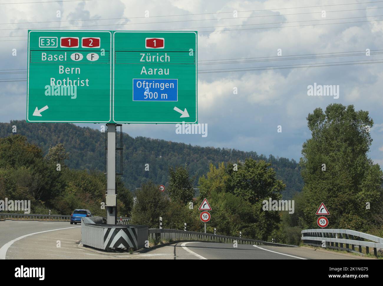 road sign of the Swiss highway with directions to reach famous European cities Stock Photo