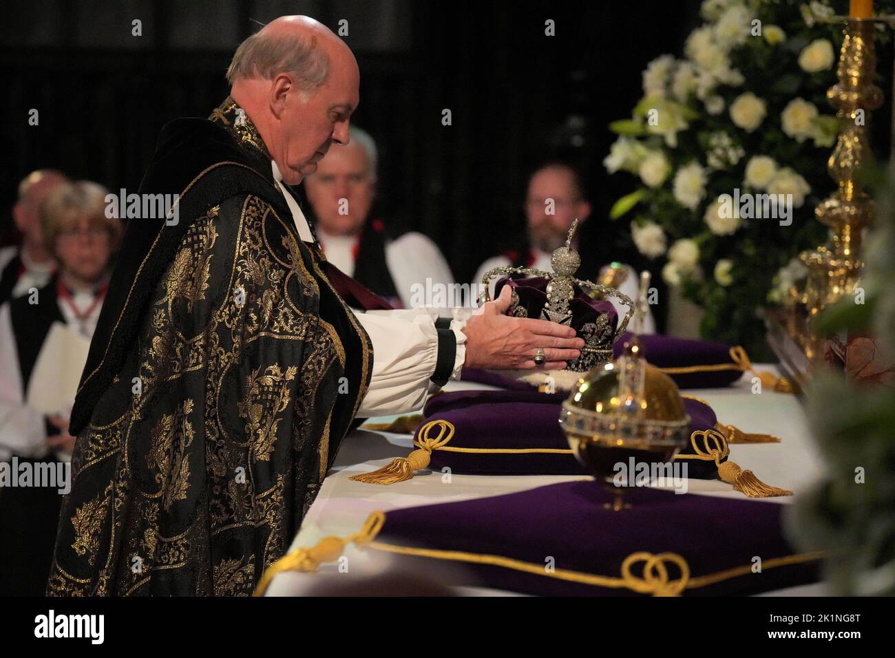 The Dean of Windsor, The Rt Revd David Conner, places the Imperial State Crown, and orb and sceptre on the high altar during the Committal Service for Queen Elizabeth, at St George's Chapel in Windsor Castle, Berkshire. Picture date: Monday September 19, 2022. Stock Photo