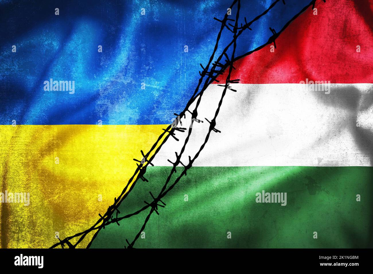 Grunge flags of Ukraine and Hungary divided by barb wire illustration, concept of tense relations between two countries Stock Photo