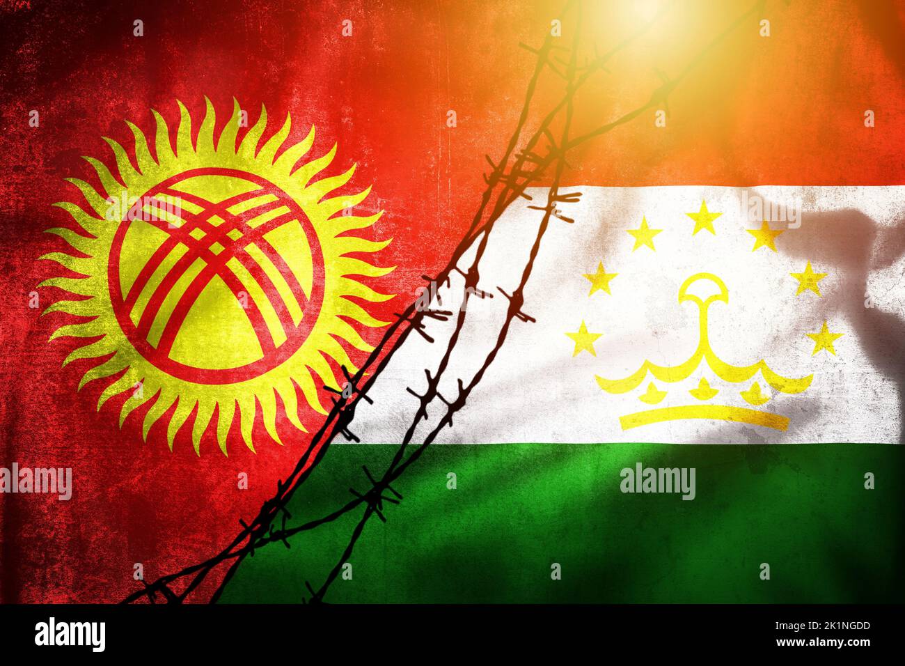 Grunge flags of Kyrgyzstan and Tajikistan divided by barb wire illustration sun haze view, concept of tense relations between two countries Stock Photo