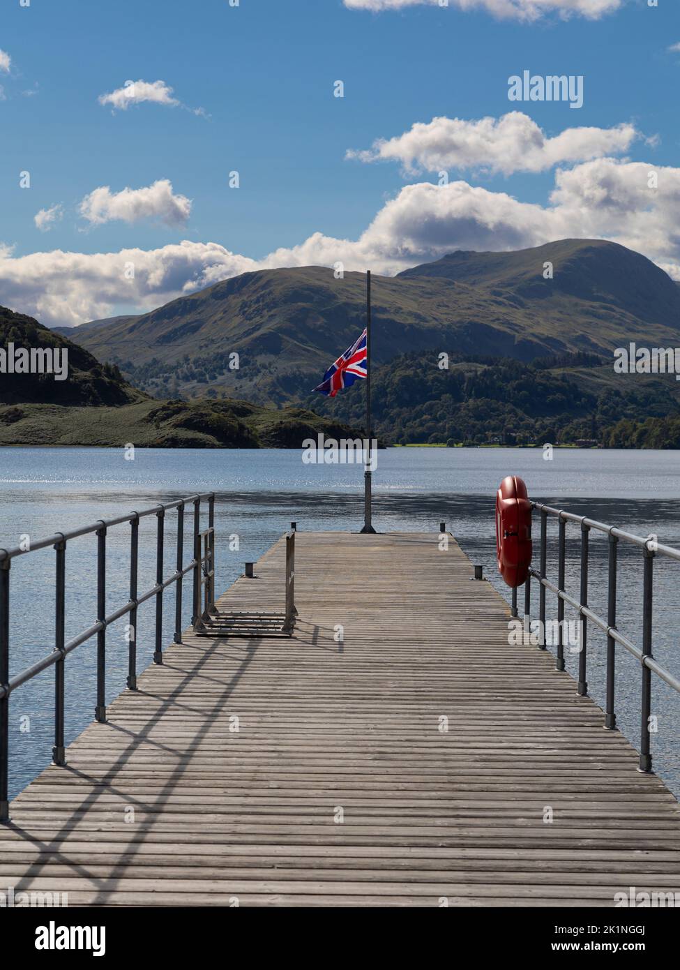 Union Flag being flown at half mast on a pier at Ullswater, Lake District Cumbria.UK. The Flag