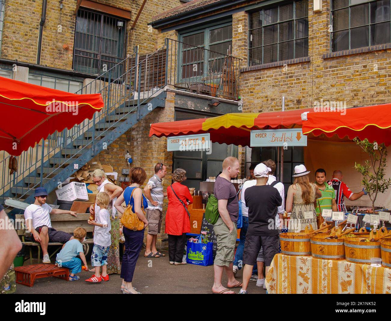 London United Kingdom June 14 2009; People at urban saturday Farmers Market perusing the fresh and prepared produce. Stock Photo
