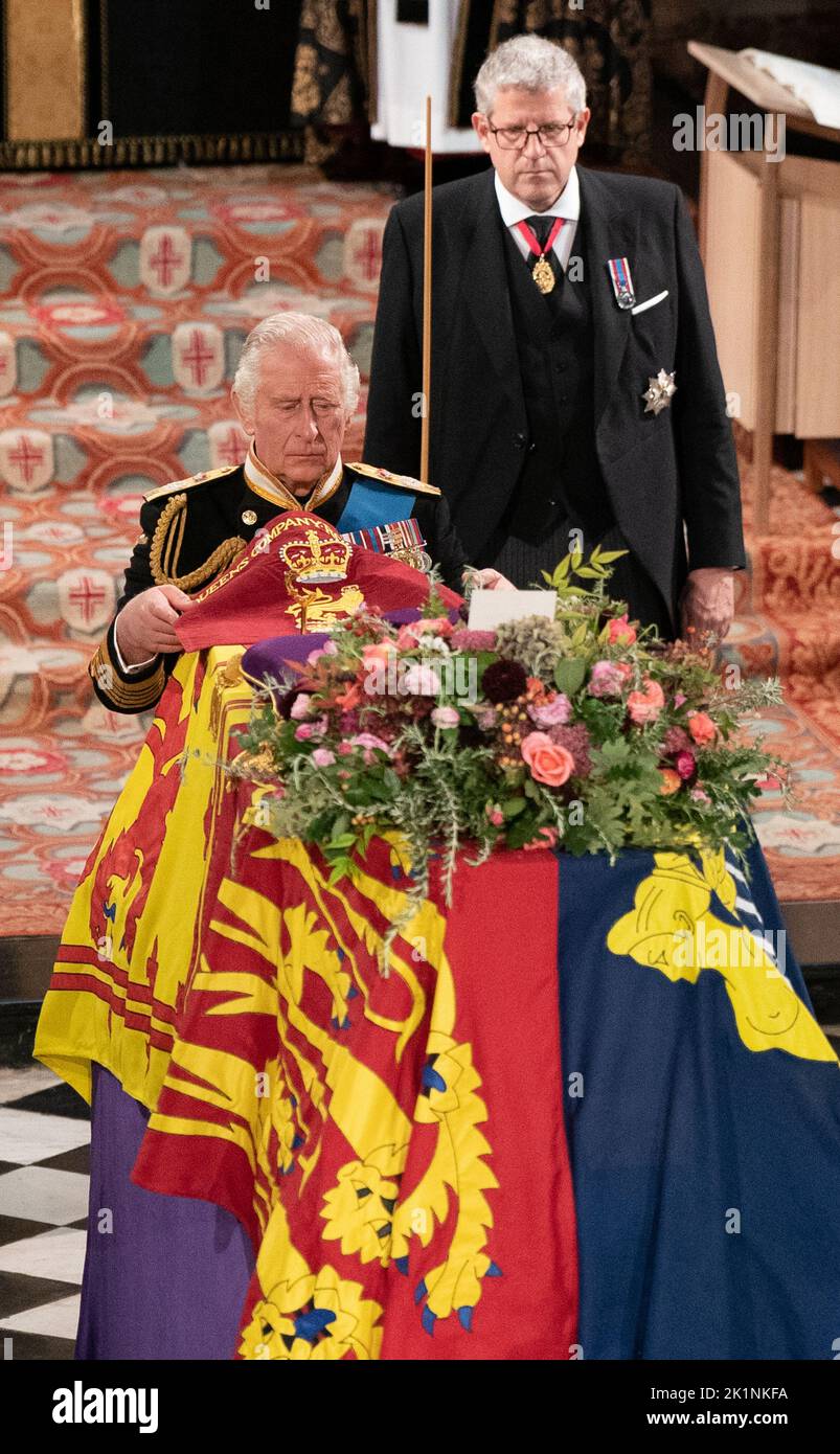 King Charles III places the Queen's Company Camp Colour of the Grenadier Guards on the coffin during the Committal Service at St George's Chapel in Windsor Castle, Berkshire. Picture date: Monday September 19, 2022. Stock Photo