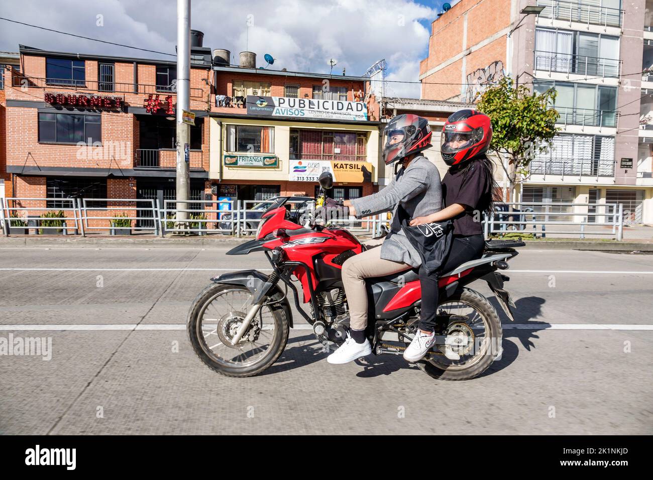 Bogota Colombia,Avenida El Dorado,couple couples riding motorcycle helmets passenger passengers man men male woman women female,Colombian Colombians H Stock Photo