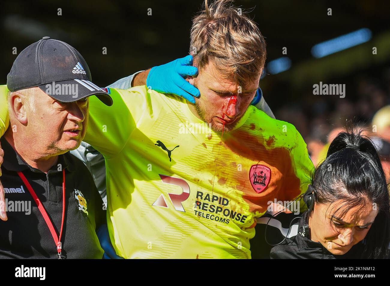 Goalkeeper Brad Collins ( 40 Barnsley) helped off the pitch with gash
