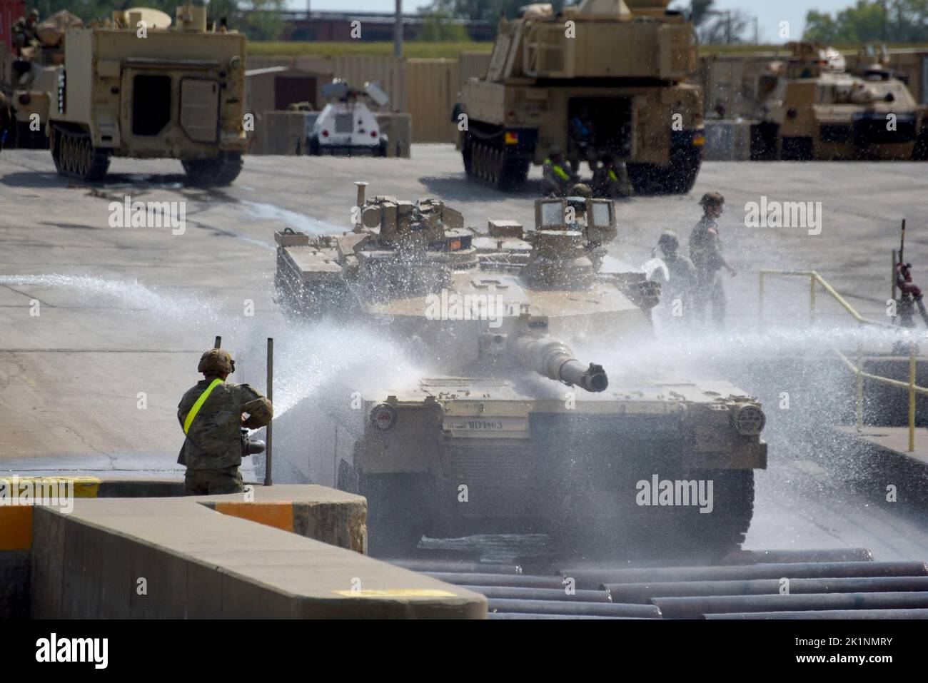 Soldiers wash an M1 Abrams tank at Fort Riley, Kansas’ Installation Vehicle Wash Facility, a tactical vehicle wash and treatment system, Sept. 15. Under a U.S. Army Engineering and Support Center’s Base Operations program contract, Skookum Contract Services maintains the IVWF daily use schedule, coordinates drive ins and briefs units on wash facility usage requirements. Stock Photo