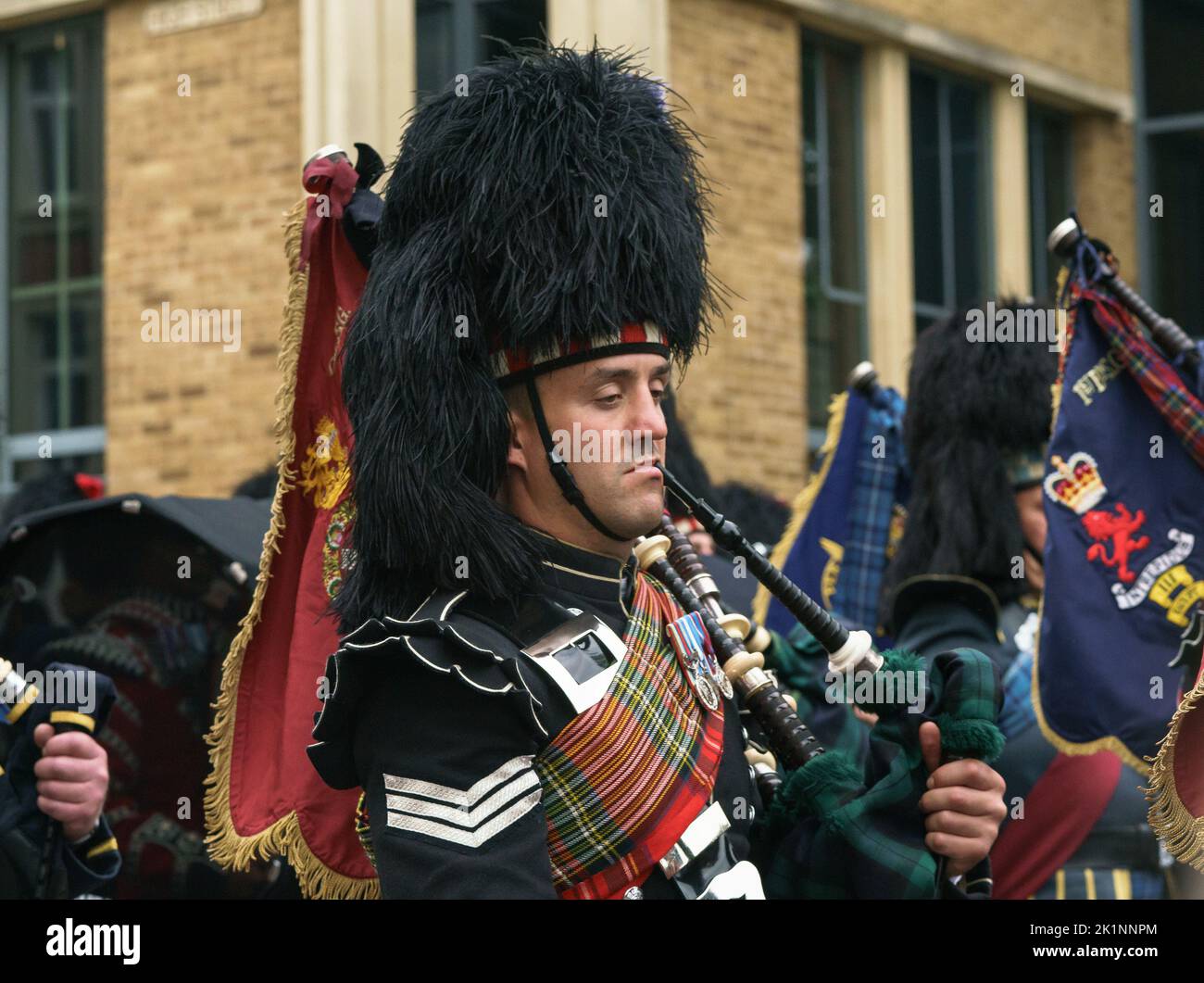 A piper marches through Windsor town, having accompanied the late Queen Elizabeth II to Windsor Castle. Stock Photo