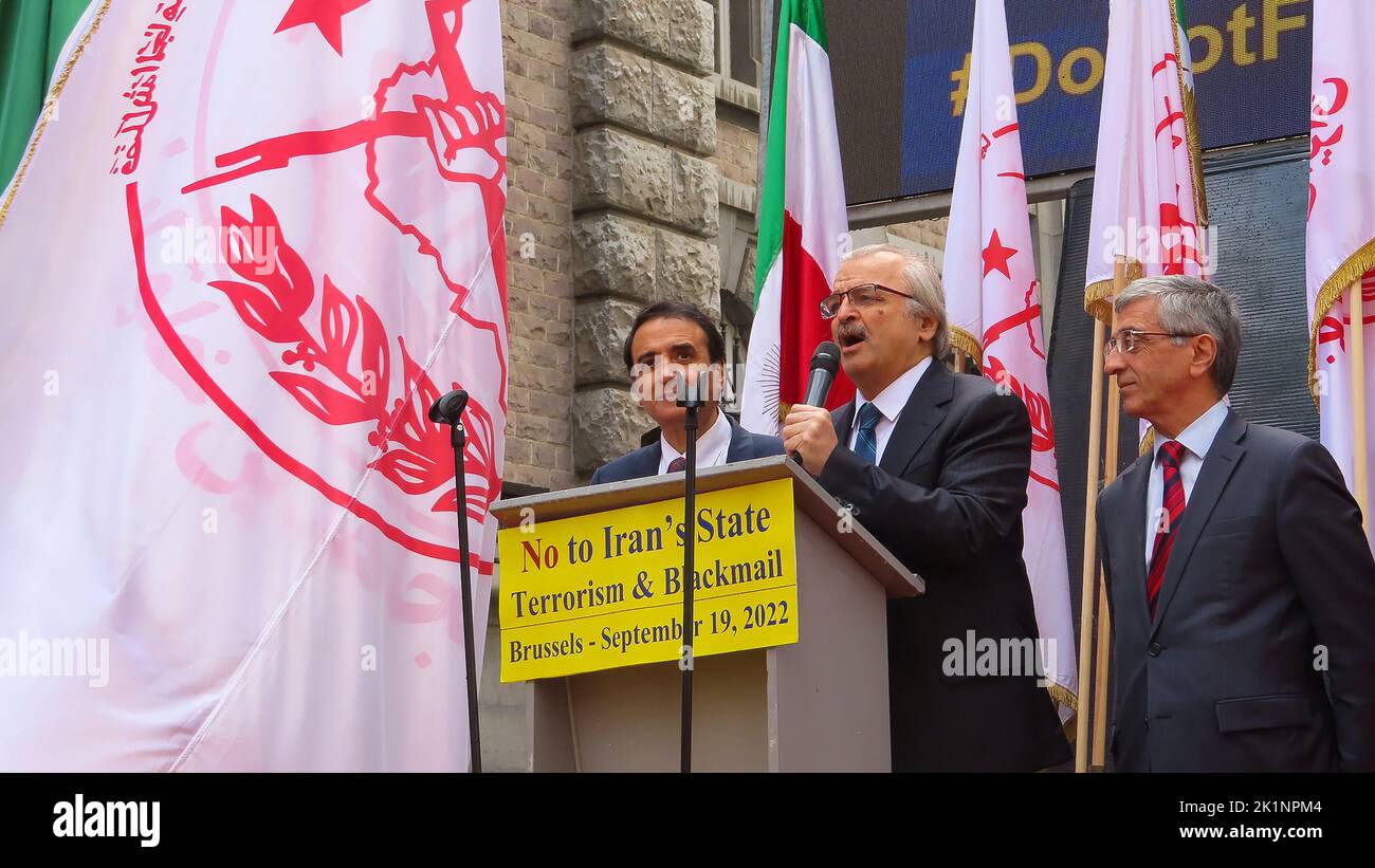 Mohammad Mohaddessin (C), chairman of the National Council of Resistance of Iran's Foreign affairs committee speaks during the demonstration. Iranians took part in a rally in front of the Belgium Foreign Ministry in Brussels while carrying photos of Maryam Rajavi, the Iranian opposition leader. Iranians urged the government to cancel the agreement that sets the stage for the return of Assadollah Assadi, an Iranian diplomat to Iran. Assadi was condemned to 20 years in prison by a Belgium court for masterminding a plot to bomb a major international gathering in Paris of the Iranian opposition an Stock Photo