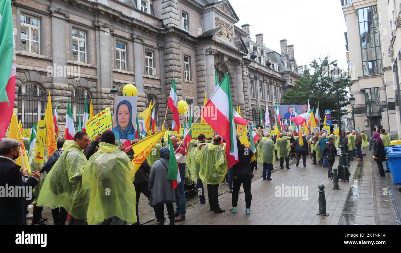 Protesters hold flags and photos of Maryam Rajavi, the Iranian opposition leader during the demonstration. Iranians took part in a rally in front of the Belgium Foreign Ministry in Brussels while carrying photos of Maryam Rajavi, the Iranian opposition leader. Iranians urged the government to cancel the agreement that sets the stage for the return of Assadollah Assadi, an Iranian diplomat to Iran. Assadi was condemned to 20 years in prison by a Belgium court for masterminding a plot to bomb a major international gathering in Paris of the Iranian opposition and is currently in jail in Belgium. Stock Photo