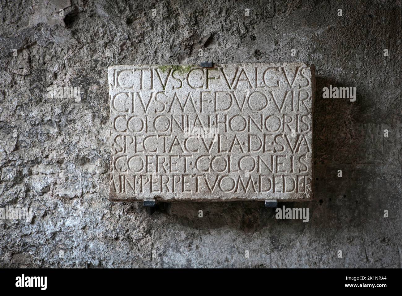 Plaque with latin inscription now fixed to wall of south exit from the Amphitheatre at Pompeii, Stock Photo