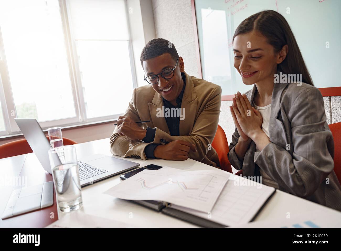 Smiling coworkers cooperating and working together at coworking space, teamwork concept Stock Photo