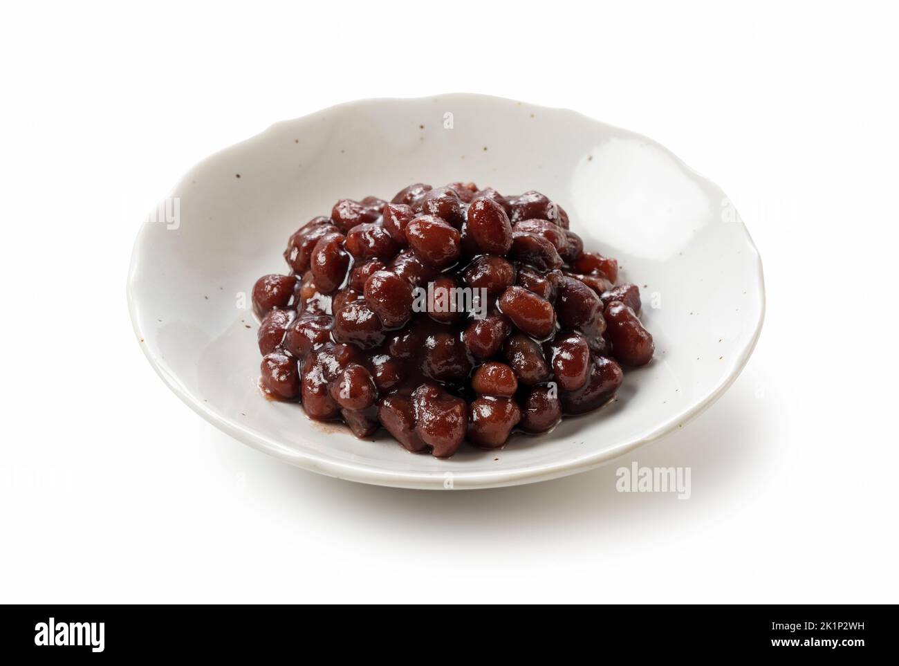 Boiled azuki beans in a dish placed on a white background. Stock Photo