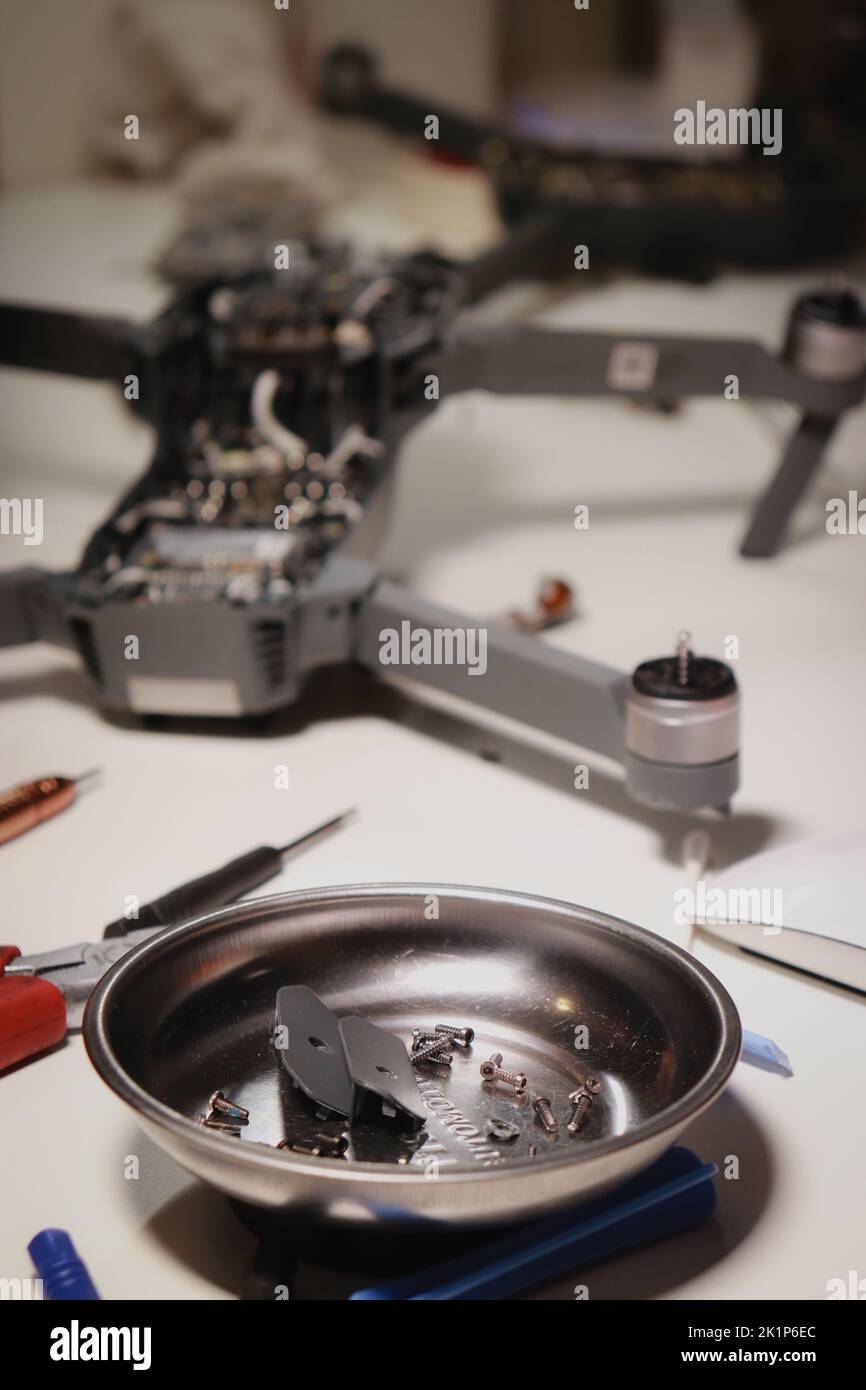 close up of different repairing tools and a drone, on white table Stock Photo