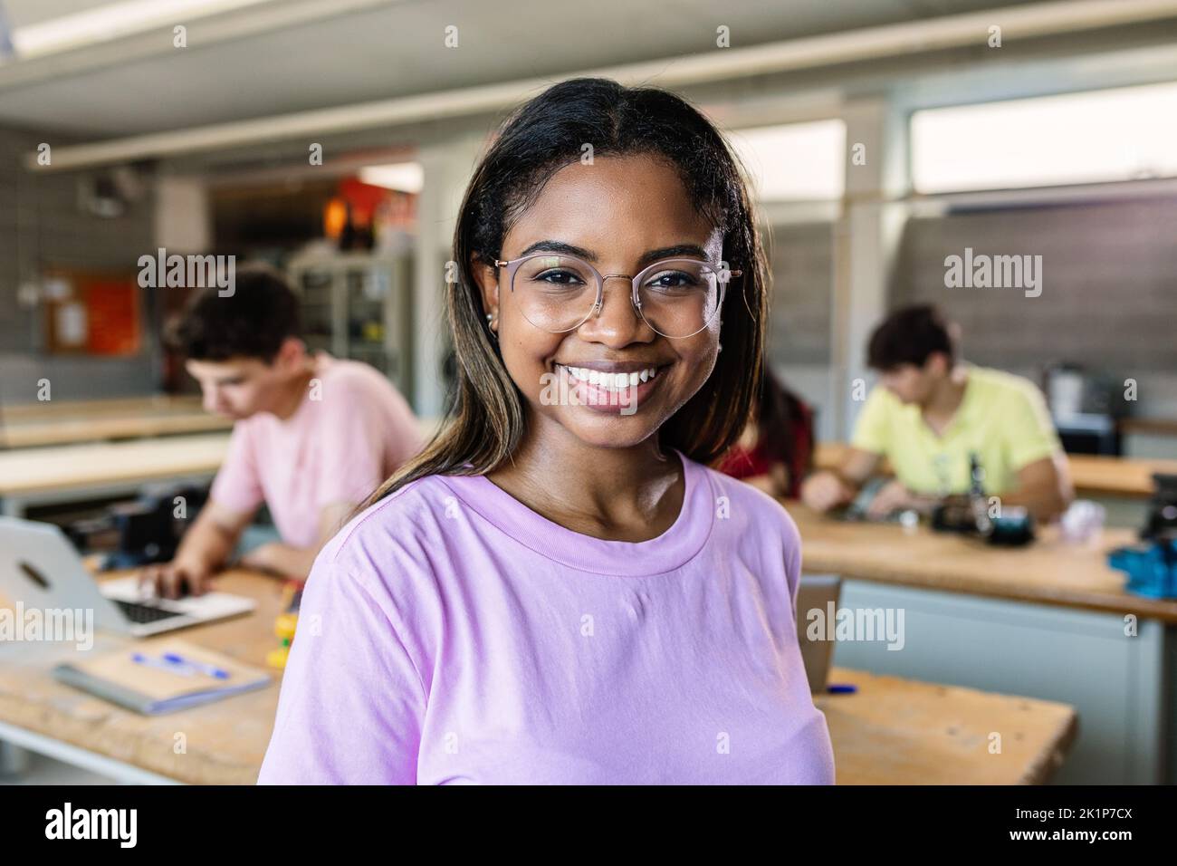 Portrait of young latin student woman smiling at camera standing at classroom Stock Photo