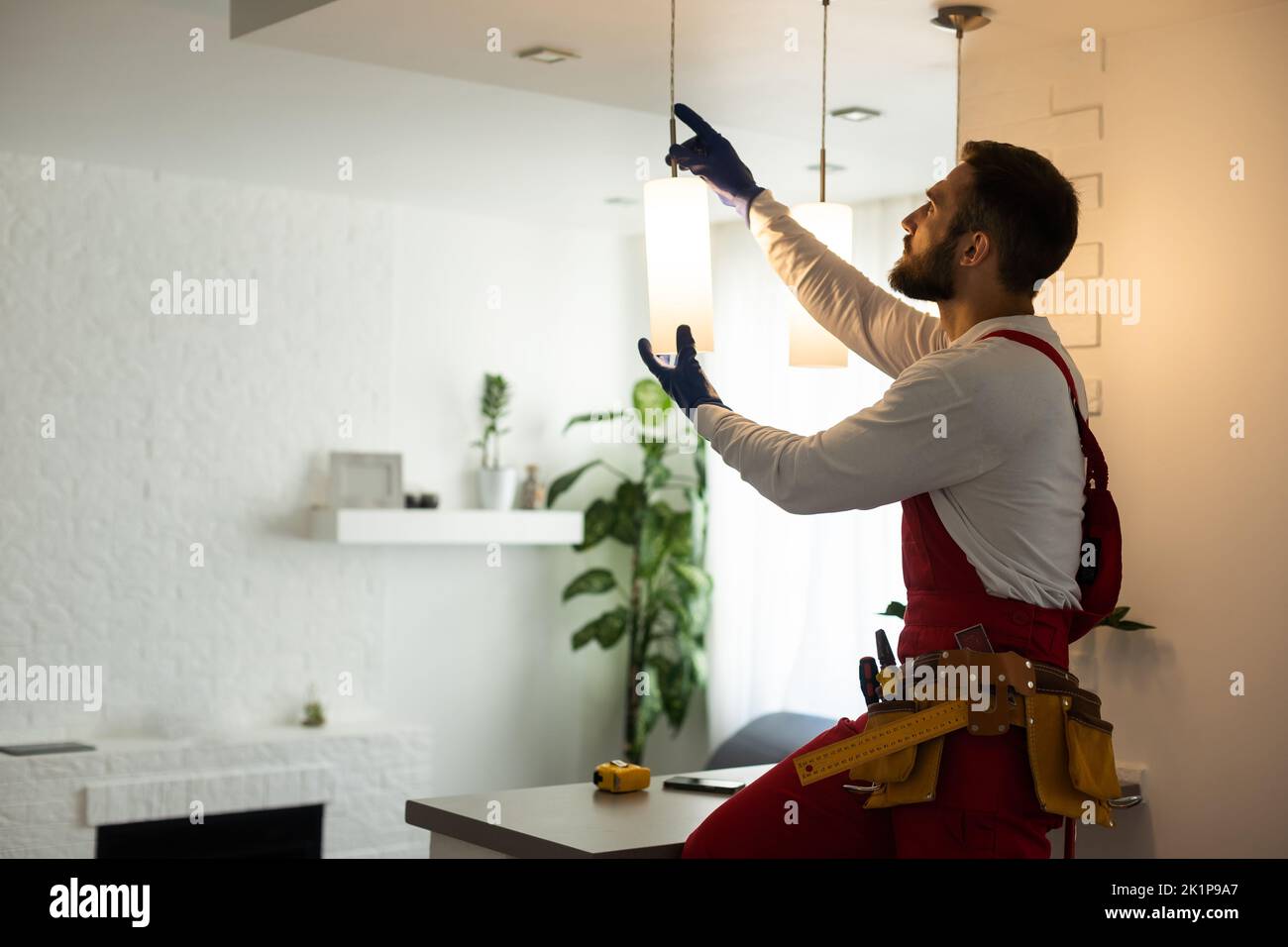 electrician installing led light bulbs in ceiling lamp Stock Photo - Alamy