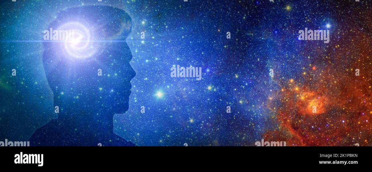Silhouette of a man's head with aura chakras on space. Beyond the Mind. Silhouette of man with space as brain. wide banner, copy space. Elements of th Stock Photo