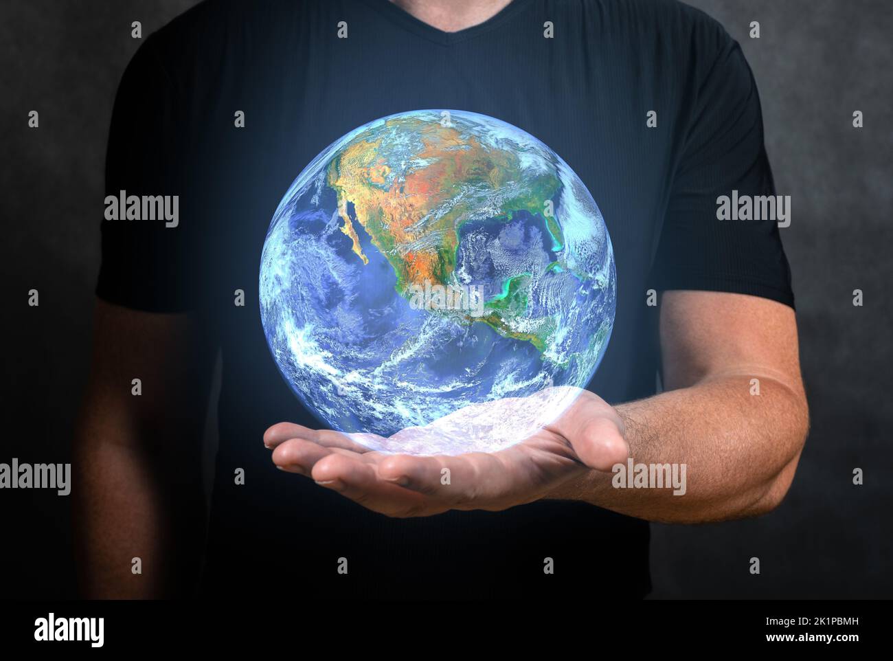 Man holds in his hand hologram of planet Earth. Earth in hands, Man holding blue Earth, Concept of communication network, internet of things and futur Stock Photo