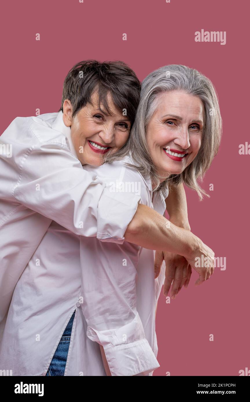 Happy smiling women hugging and looking amazing Stock Photo - Alamy