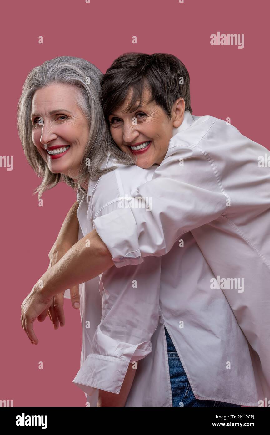 Happy smiling women hugging and looking amazing Stock Photo - Alamy