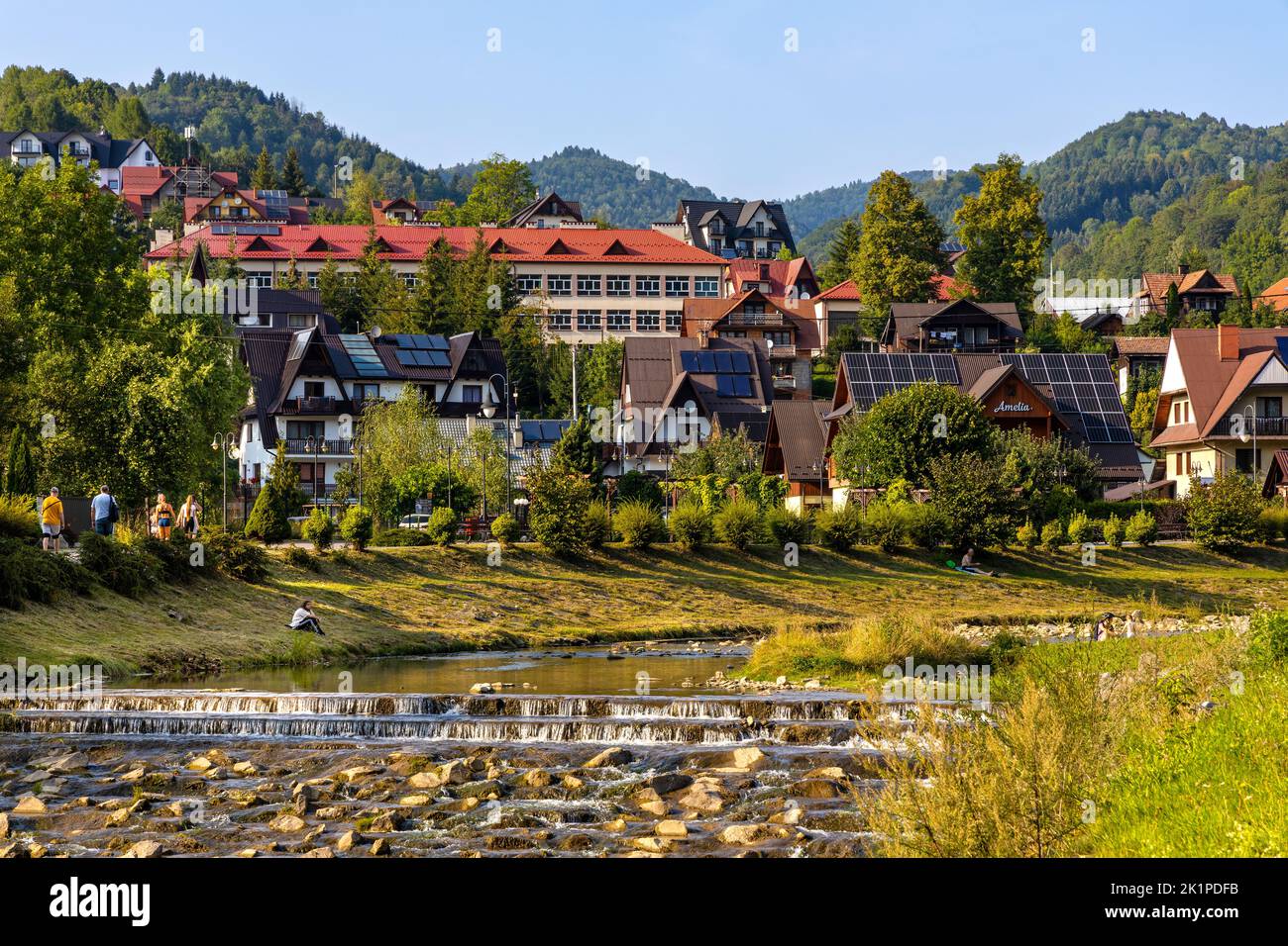 Szczawnica, Poland - August 18, 2022: Pieniny Mountains and vacation houses at Grajcarek creek joining Dunajec river in Szczawnica Zdroj springs resor Stock Photo
