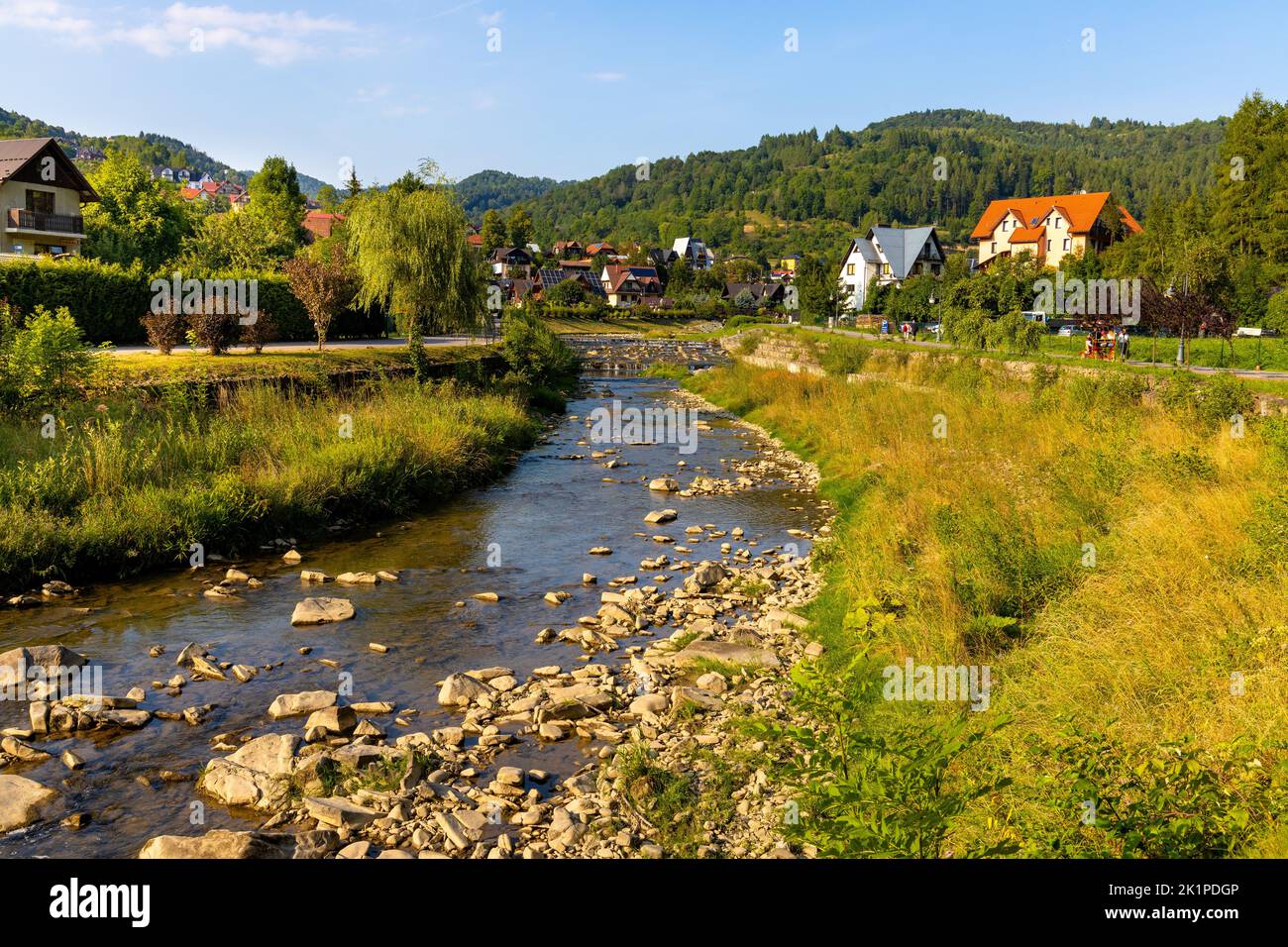 Szczawnica, Poland - August 18, 2022: Panorama of Pieniny Mountains over Grajcarek creek joining Dunajec river in Szczawnica Zdroj springs resort town Stock Photo