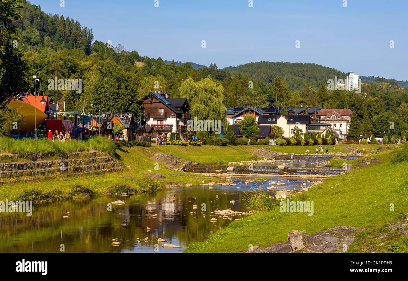 Szczawnica, Poland - August 18, 2022: Panorama of Pieniny Mountains over Grajcarek creek joining Dunajec river in Szczawnica Zdroj springs resort town Stock Photo