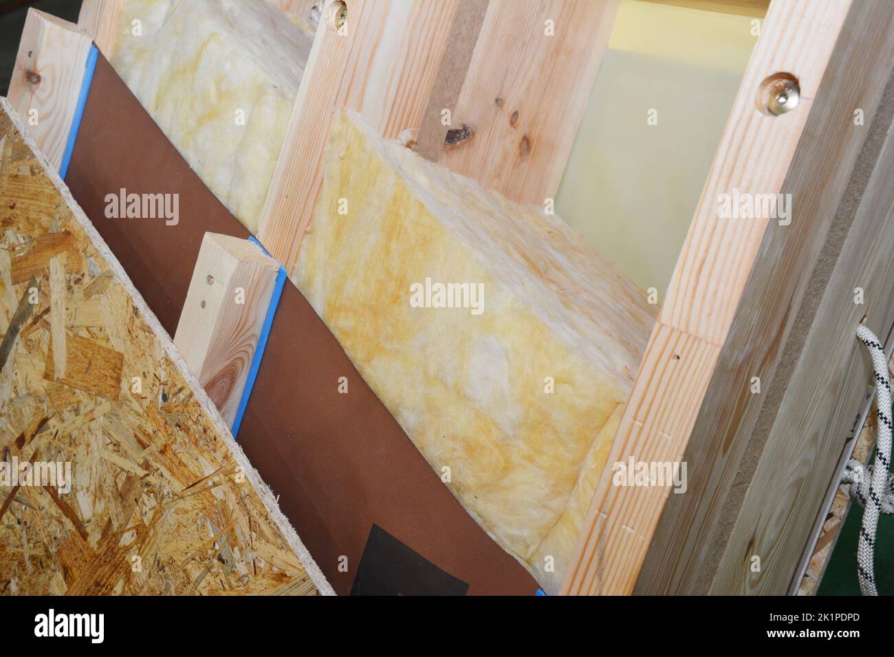 Attic roof construction with damp proof, waterproof and mineral wool insulation layers. Stock Photo