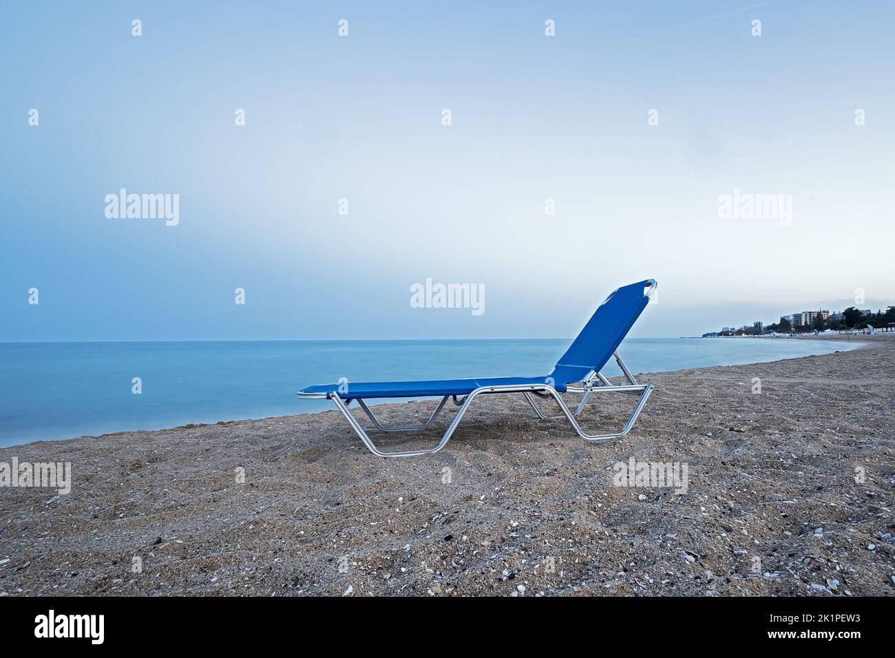 unused blue lounge chair on the beach Stock Photo