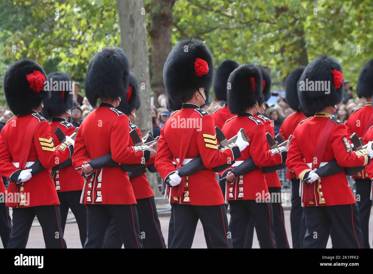 Grenadier Guards in their historic colourful uniforms accompany the funeral procession for Queen Elizabeth II on The Mall, London, UK Stock Photo